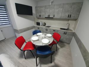 a kitchen and dining room with a table and chairs at HotelRoom 27 in Uzhhorod +20 photos