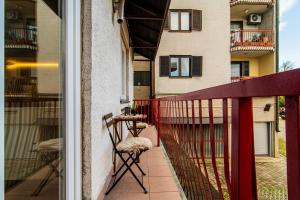 a balcony with a table and chairs and a building at Flexible SelfCheckIns 102 - Zagreb - Parking - WIFI - Loggia in Zagreb