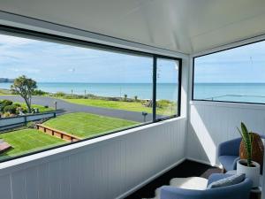 a room with a large window with a view of the ocean at Apartment 278 in Eskdale