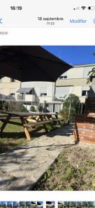 a picture of a picnic table in front of a building at Agréable Dortoir en bord de jardin Lit 3 in Castres
