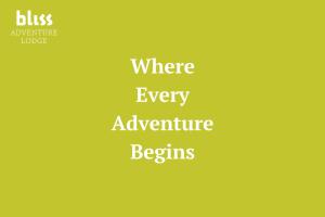 a yellow sign with the words where every adventure begins at Bliss Adventure Lodge in Pyhätunturi