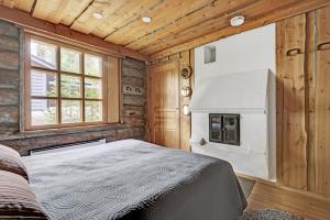 a bedroom with a bed in a room with wooden walls at Bliss Adventure Lodge in Pyhätunturi