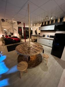 a kitchen with a large wooden table and chairs at L'escapade sensuelle - la love room d'Epernay in Épernay