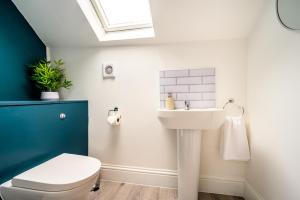 a bathroom with a sink and a toilet at Stunning House Sleeps 7 - Parking in Buxton +26 photos