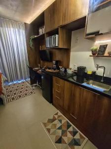 a kitchen with a sink and a counter top at On Paulista - Confort Studio in São Paulo +9 photos