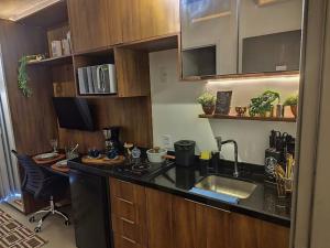 a kitchen with a sink and a counter top at On Paulista - Confort Studio in São Paulo
