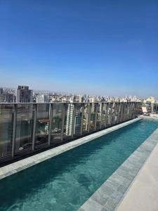 a swimming pool on the roof of a building at On Paulista - Confort Studio in São Paulo