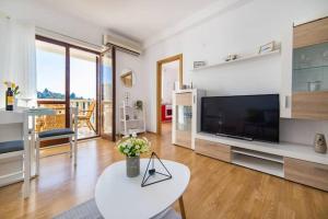 a living room with a large television and a table at Apartments Luxury apartments in Ploče