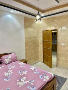 a bedroom with a bed with a purple comforter at Appartement meublés in Dakar +3 photos