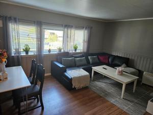 a living room with a couch and a table at Frozen Arctic Waterfall Appartment in Tromsø