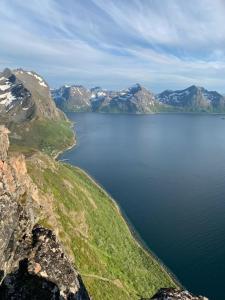 an aerial view of a body of water with mountains at Frozen Arctic Waterfall Appartment in Tromsø