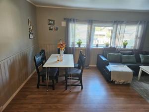 a living room with a table and a couch at Frozen Arctic Waterfall Appartment in Tromsø +9 photos