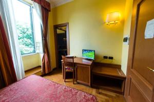 a bedroom with a desk with a computer on it at Hotel Lella in Rome