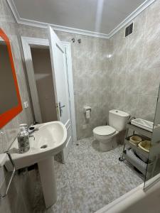 a bathroom with a sink and a toilet at Rincón de la Habana in Siero