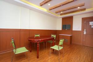 a conference room with a red table and chairs at Super Capital O Kovilakam Residency in Trichūr +34 photos