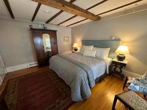 a bedroom with a large bed and two lamps at Abalonia Inn in Ogunquit +74 photos
