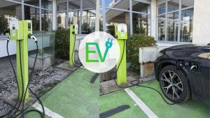 a charging station with a car parked in front of a building at LUX apartments in Central park in Banská Bystrica +24 photos