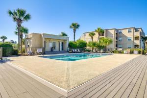默特尔比奇Private Beach and Pool Access Murrells Inlet Condo!的棕榈树环绕的建筑物前的游泳池