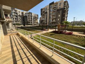 a walkway in an apartment complex with buildings at Spacious 3BR Apt, 2 Baths, Gated Community - 903 in Sheikh Zayed