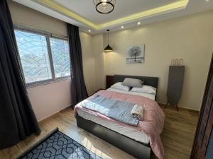 a bedroom with a bed and a large window at Spacious 3BR Apt, 2 Baths, Gated Community - 903 in Sheikh Zayed