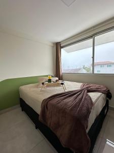 Ένα ή περισσότερα κρεβάτια σε δωμάτιο στο Flamingo Pé na areia Guaratuba