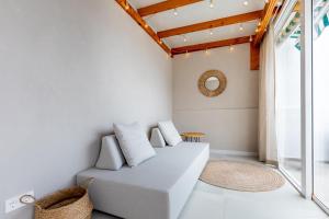a living room with a couch and a mirror at Stylish family home in Los Gigantes in Santiago del Teide