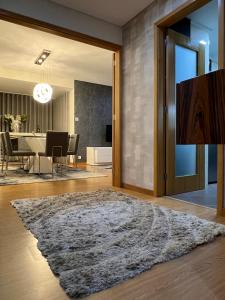 a living room with a table and a large rug at Douro Residence Porto Gaia in Vila Nova de Gaia +18 photos
