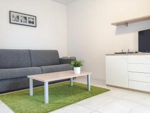 a living room with a couch and a table at Apartments Lucija in Portorož +8 photos