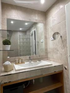a bathroom with a sink and a mirror at Beautiful Marbella Apartment in Marbella +48 photos
