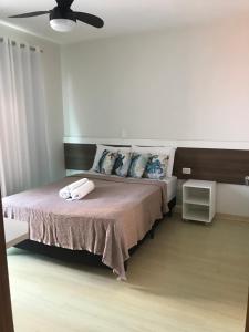a bedroom with a bed and a ceiling fan at Pousada Souza & Souza in Barra Velha