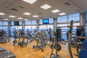 a gym with a lot of treadmills and ellipticals at Stella Residence Club in Odesa