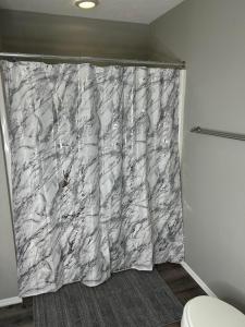a shower curtain in a bathroom with a toilet at Cozy condo with no stairs, and arcades! 5 beds in Branson +18 photos