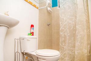 a bathroom with a toilet and a shower curtain at Sunset View - Mini Loft in La Libertad +54 photos