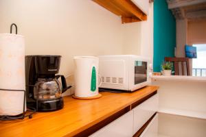 a kitchen counter with a microwave and a coffee maker at Sunset View - Mini Loft in La Libertad