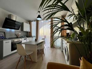a kitchen with a table and a potted plant at Costa Adeje Relax y vistas al mar desde terraza in Adeje