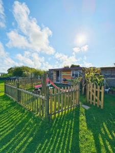 a wooden fence in front of a house at Sunrise Cabin in Carbis Bay