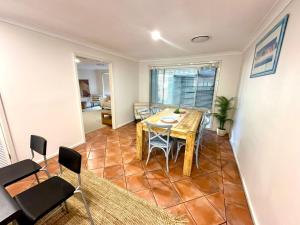 a dining room with a table and chairs at Zennor House - Busselton in Busselton +23 photos