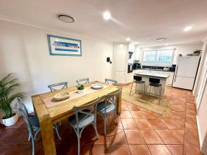 a kitchen and dining room with a table and chairs at Zennor House - Busselton in Busselton