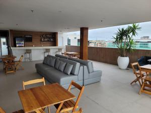 a living room with a couch and a table at HOTEL BOSSA NOVA 224 - Ótimo Apto com cozinha para até 03 hóspedes in Cabo Frio +36 photos