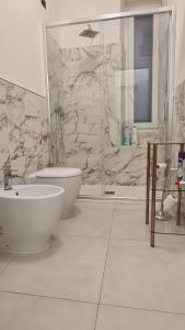 a bathroom with a toilet and a sink and a shower at Le mie stelle 1 in La Spezia +63 photos