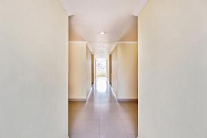 an empty hallway with columns in a building at Super Hotel O Golden Hive Madhapur Near Shilparamam in Hyderabad