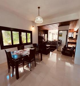 a dining room and living room with a table and chairs at Rodeio das Lagoas Pousada in Cambara do Sul