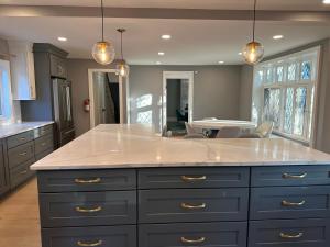 a kitchen with a large island with white counter top at 7BR Spacious Property Perfect For up to 15! in Orange +66 photos