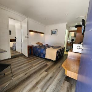 a hotel room with a bed and a desk at Byer Fountain Motor Inn in Holbrook