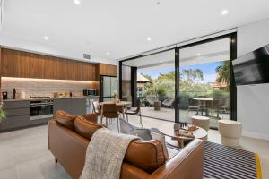 a living room with a couch and a table at Coogee Beachside Hideaway 3 in Sydney