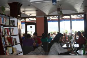 a group of people sitting at tables in a restaurant at Green Hotel in Dharamshala