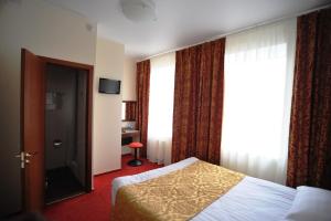 Кровать или кровати в номере Отель Винтаж Шереметьево