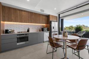 - une cuisine avec une table, une table et des chaises dans l'établissement Coogee Beachside Solace #5 - Peaceful 1BR, Pet Friendly Escape, à Sydney