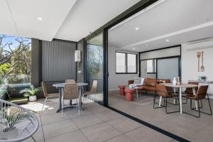 un salon avec une table et des chaises dans l'établissement Coogee Beachside Solace #5 - Peaceful 1BR, Pet Friendly Escape, à Sydney