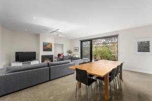 a living room with a table and a couch at Seaside Getaway in Point Lonsdale